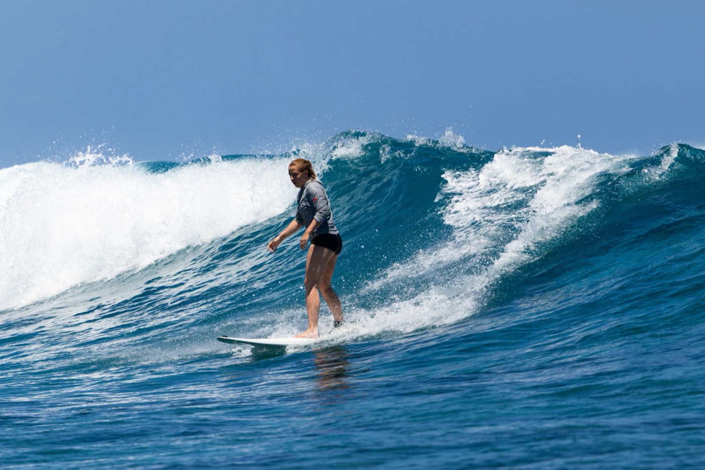 Isabella surfing a breaking wave